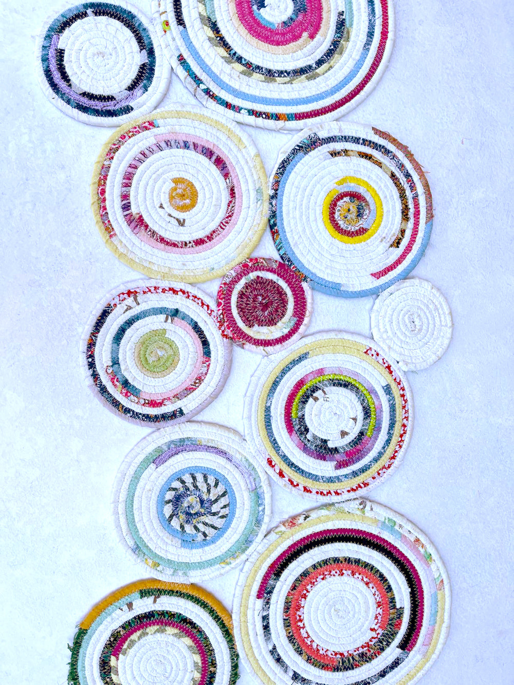 Colorful circles of fabric-covered cord stitched together into a table runner