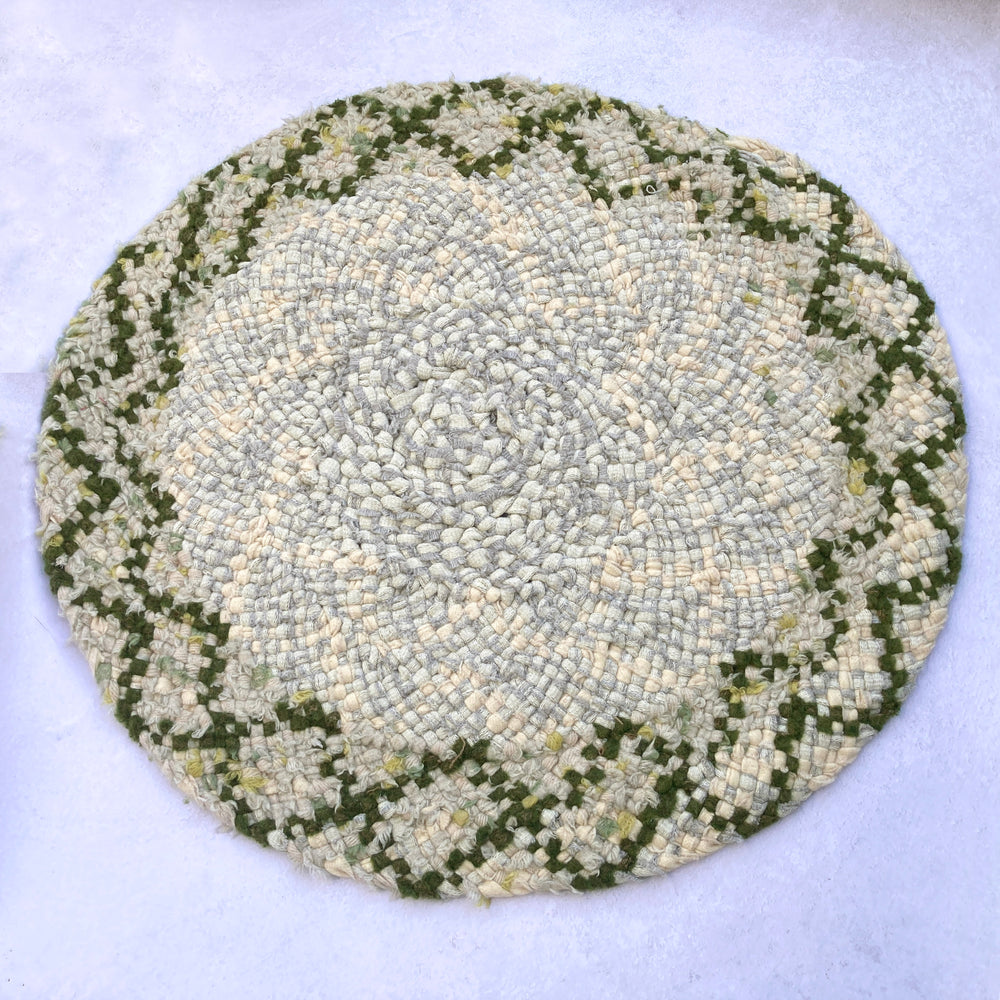 Circular braid in rag rug made using green and grey blanket textile offcuts 