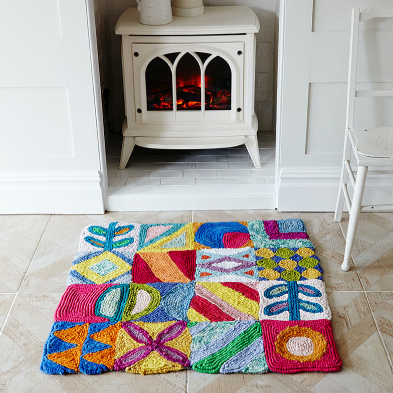 Ragged Life colourful locker hooked rag rug with geometric design on rug canvas