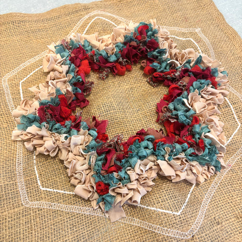 Textured rag rug star design on printed hessian hexagon