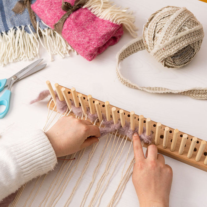 Person weaving on a peg loom, demonstrating the craft of peg loom weaving for beginners and DIY enthusiasts