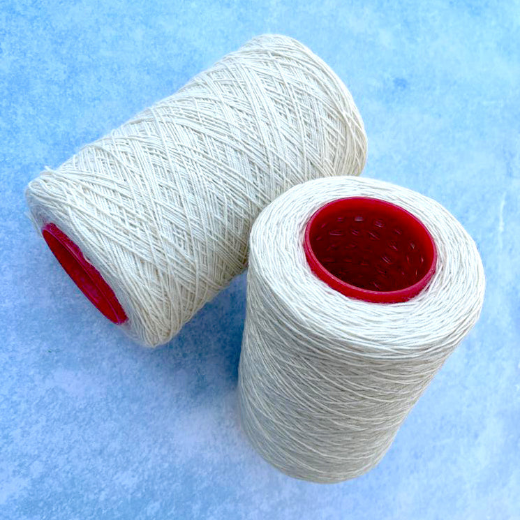 Reel of wool and nylon cream weaving warp, perfect for creating strong and durable woven projects on a peg loom and two string loom. 