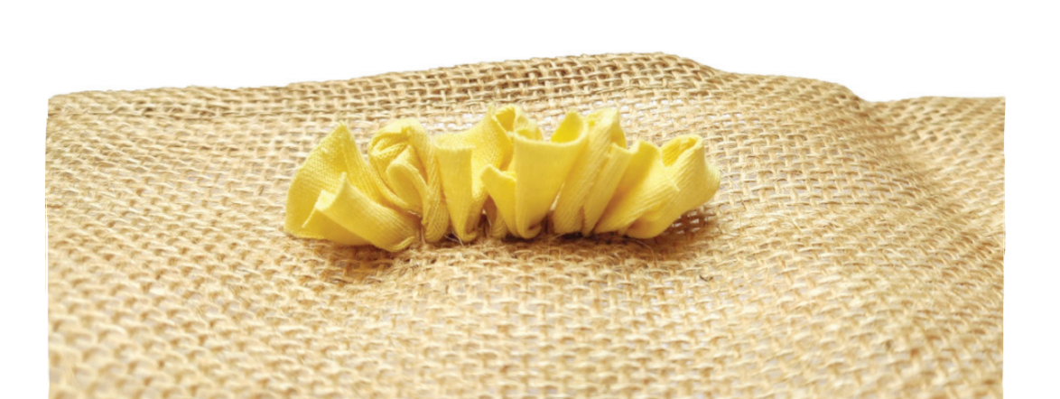 Row of short shaggy rag rugging on a hessian rug base