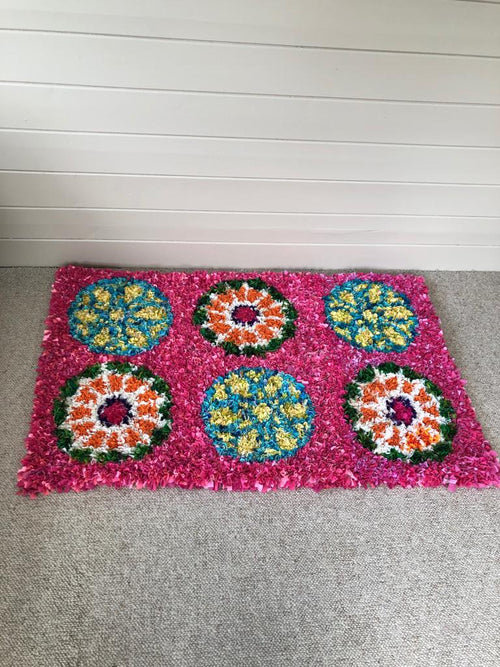 Stained glass inspired pink rag rug with circle wheel design