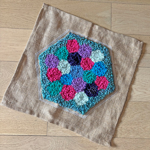 Completed rug hooked hexagon for Ragged Life Rag Rug Hive Community Patchwork project 